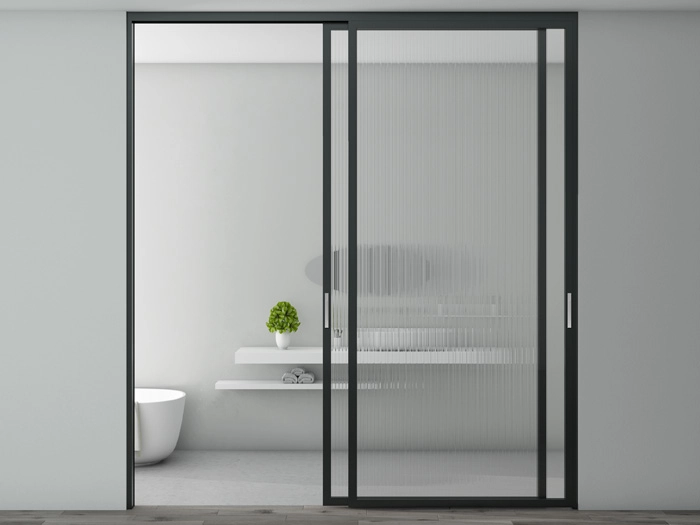 Modern aluminum sliding door opening to a bright dining area with sleek frames and energy-efficient glass panels.