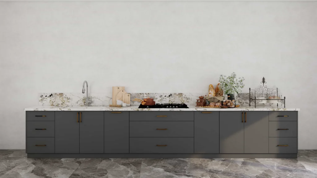 Grey base kitchen cabinets with marble backsplash and gold handles.